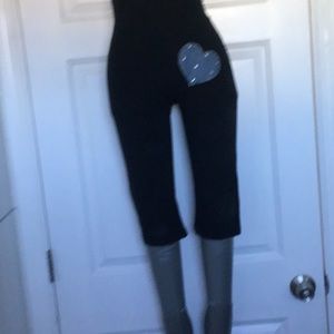 Adorable black pedal pushers size M with blue denim pockets on front and back